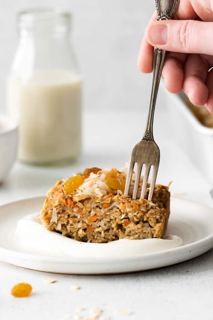 slice of morning glory baked oatmeal topped with flaked coconut