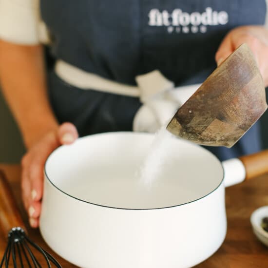 whisking salt with water in pot.