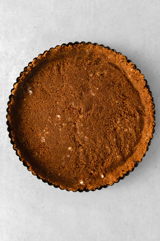Baked gingersnap crust in a tart pan.