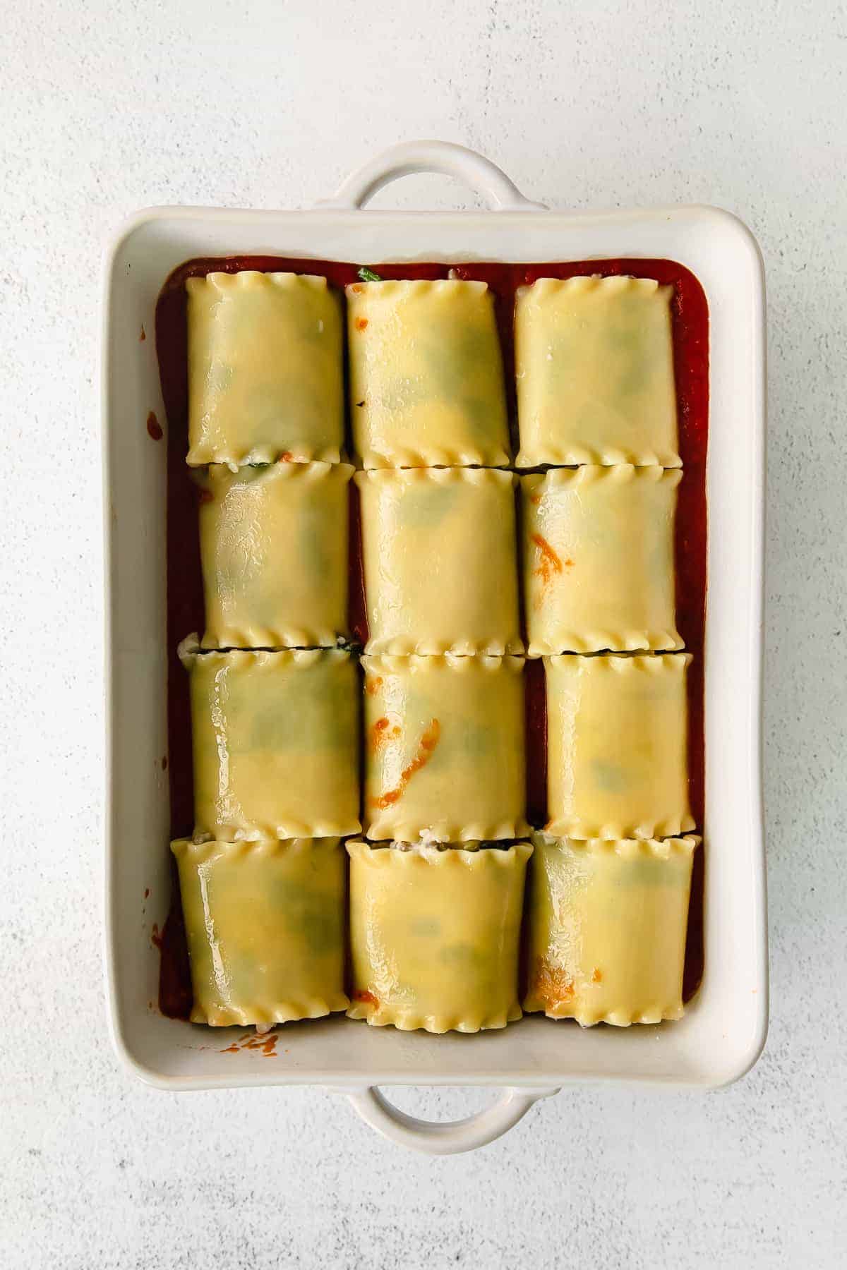 Lasagna roll ups in a casserole dish. 