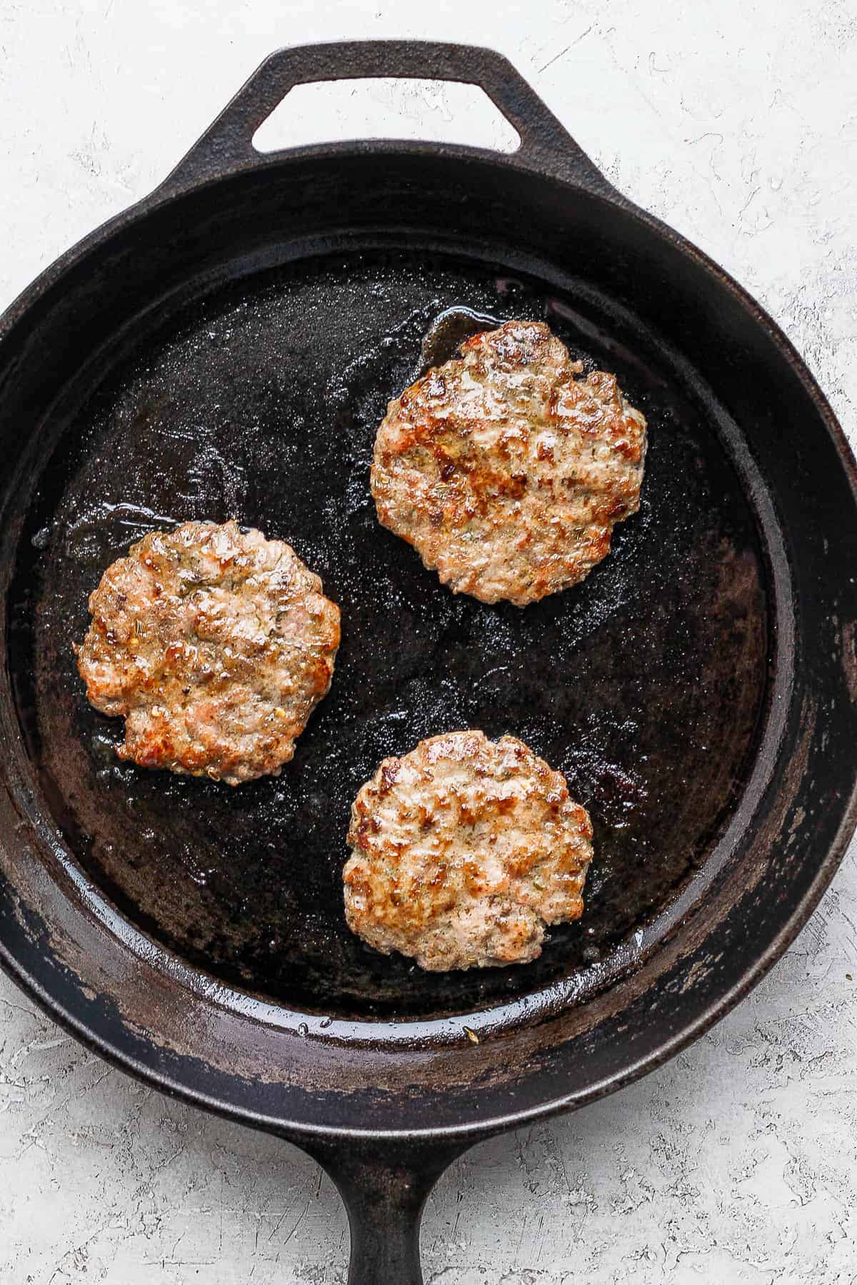 cooking sausage on cast iron skillet