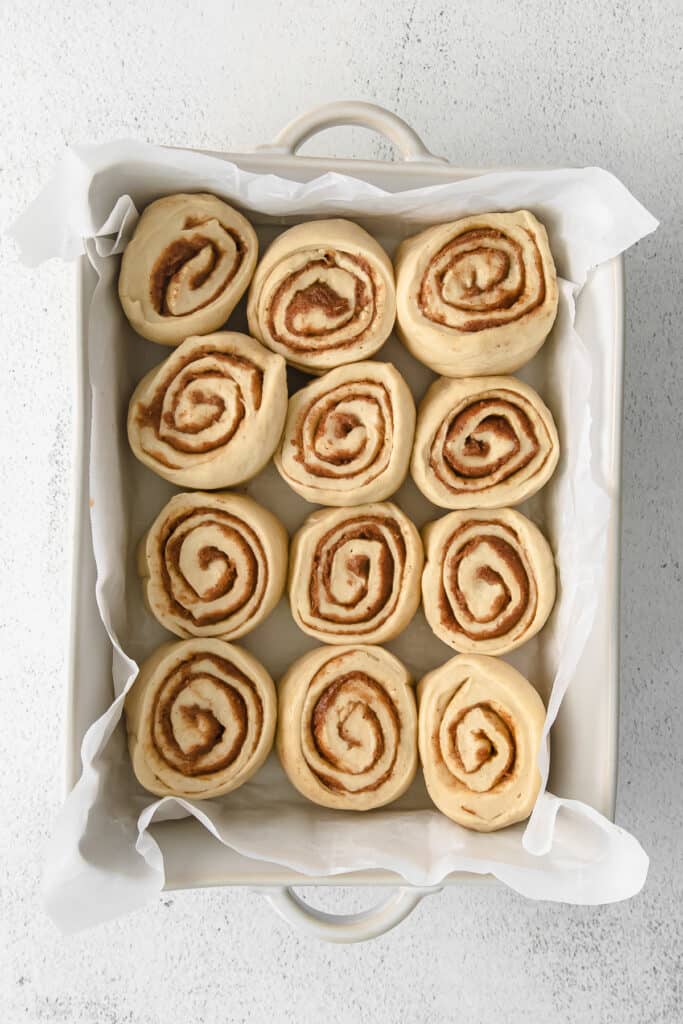 maple cinnamon rolls in a casserole dish ready to be baked