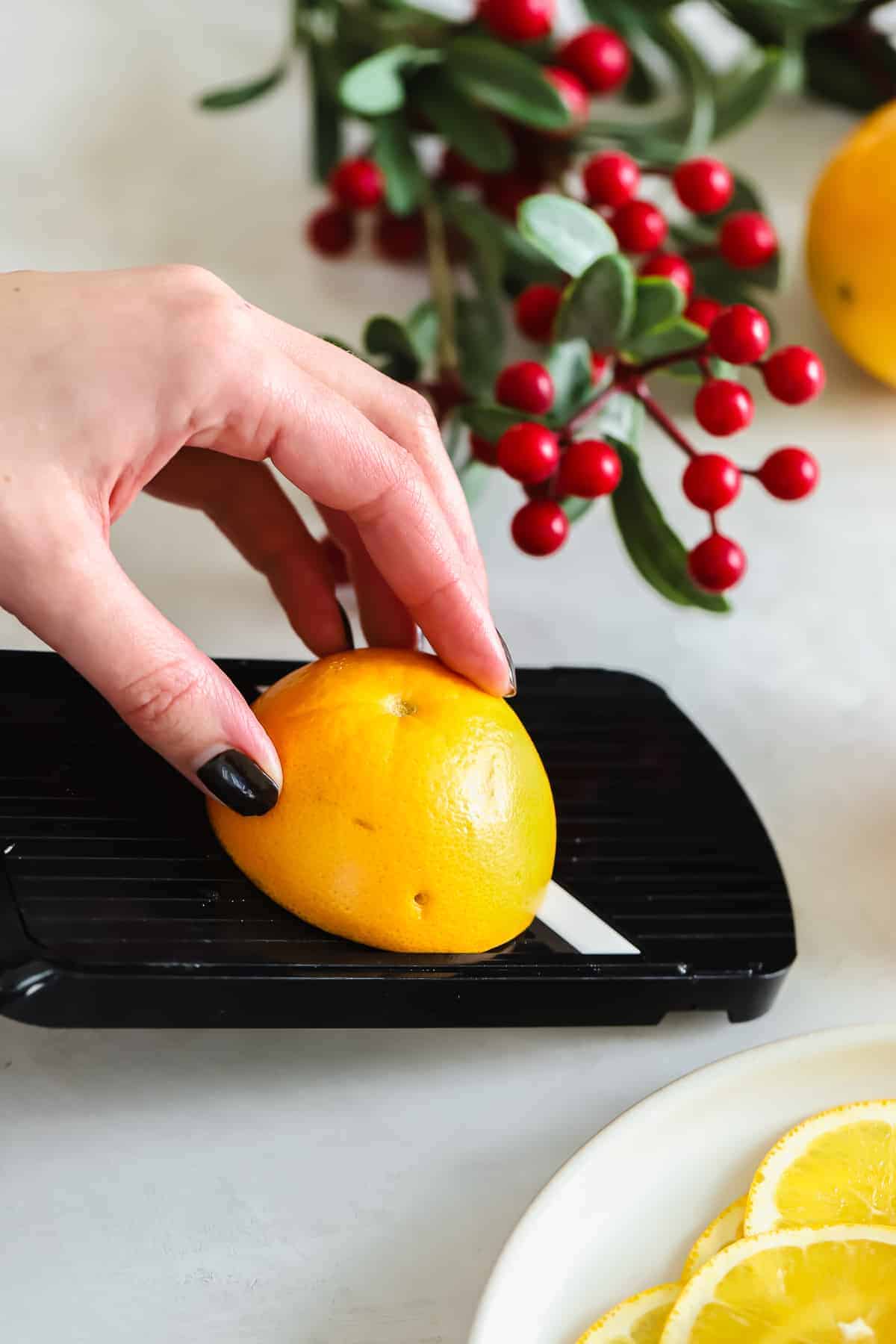 slicing an orange with a mandoline