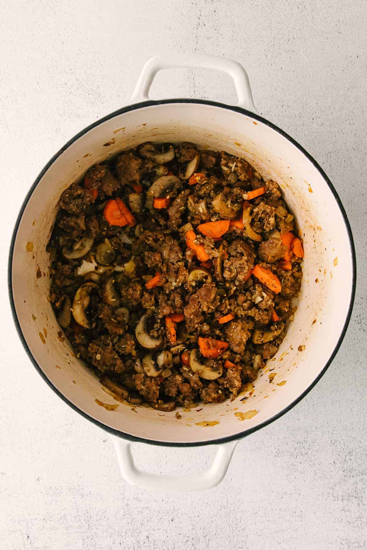 ingredients for sausage gnocchi soup in a stock pot