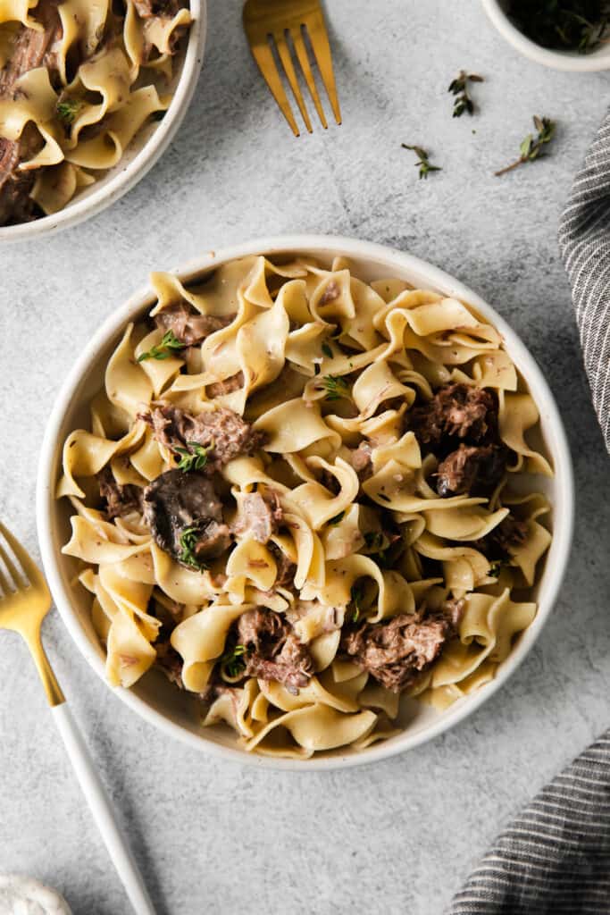 bowl of slow cooker beef stroganoff with egg noodles