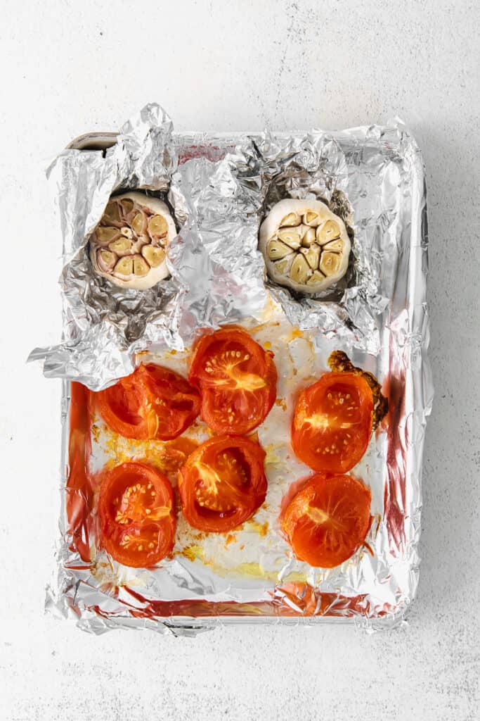 roasted tomatoes and garlic on sheet pan