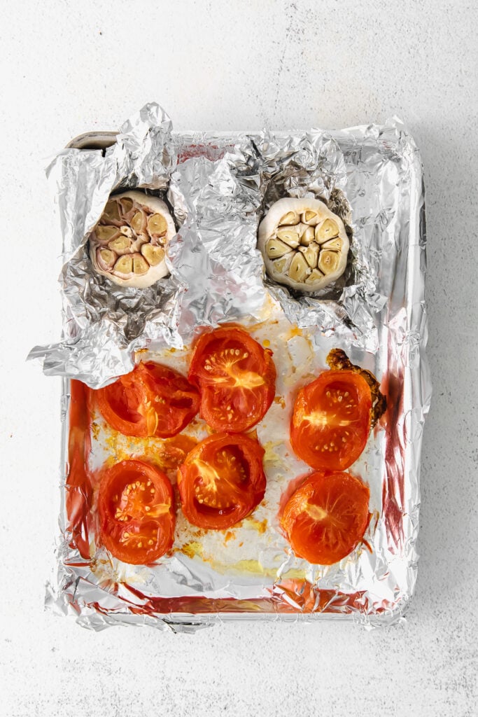 roasted tomatoes and garlic on sheet pan