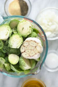 Roasted brussels sprouts in a glass bowl.