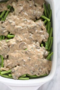 Mushrooms and green beans in a casserole dish.