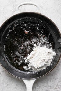 A frying pan with flour in it.