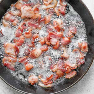Bacon cooking in a frying pan.