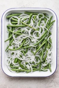 Green beans with onions in a white dish.