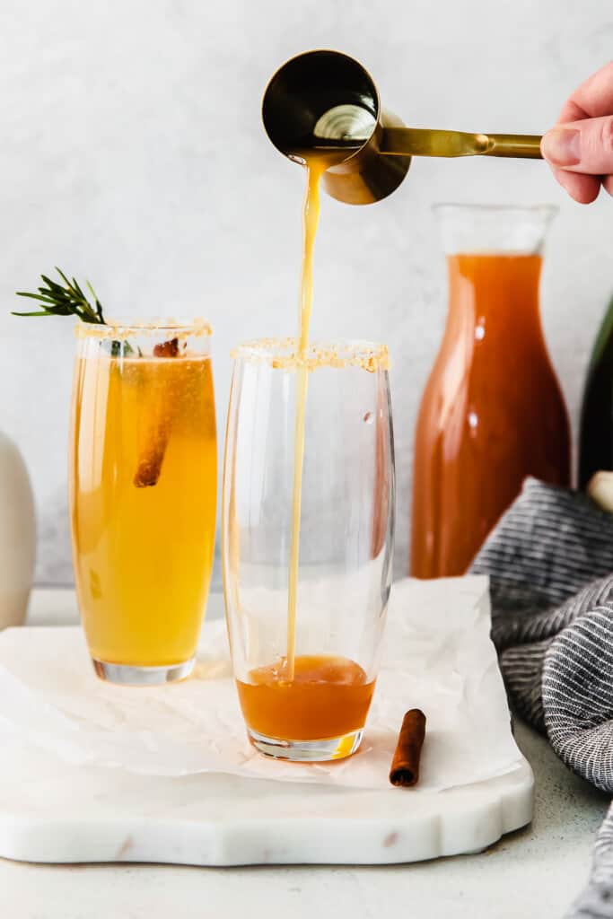 Pouring an apple cider mimosa