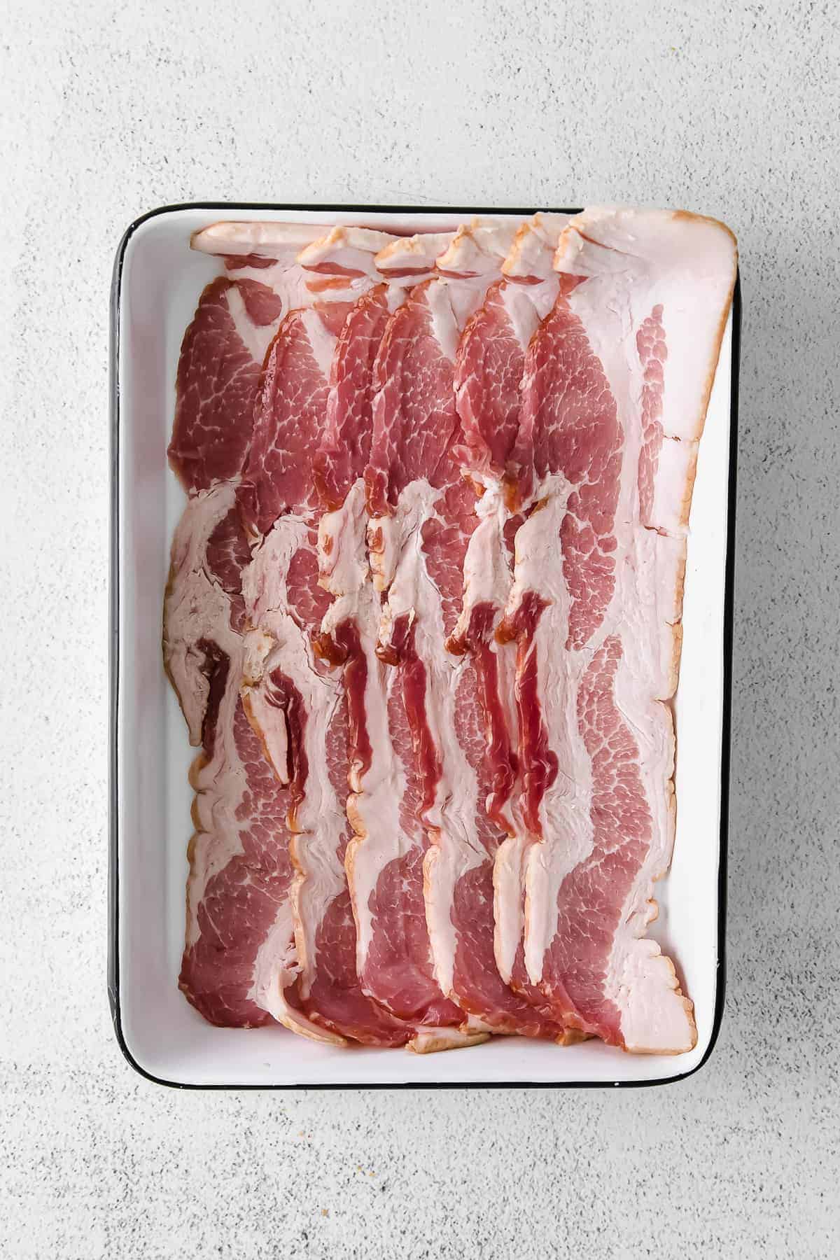 uncooked bacon in dish