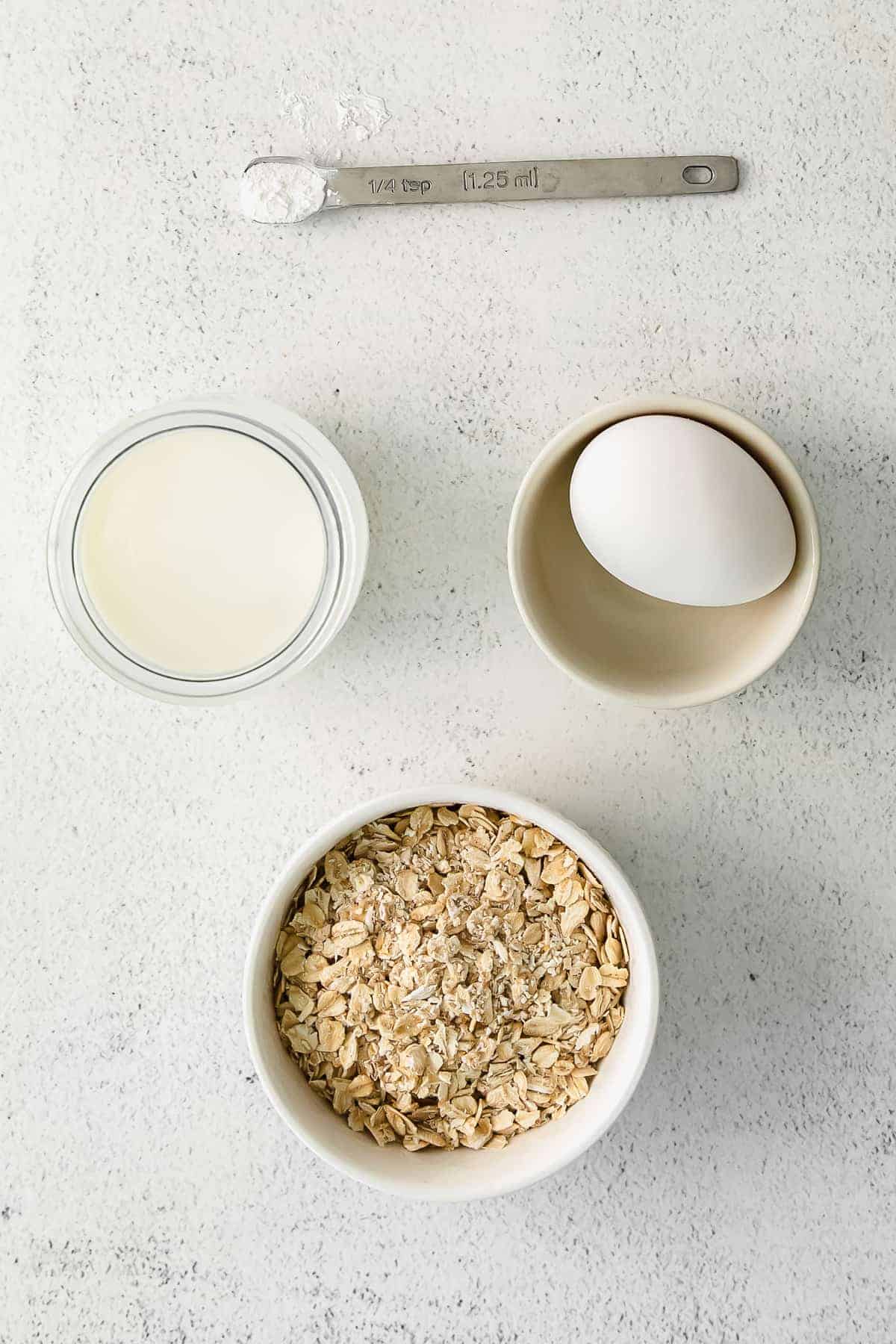 blended baked oatmeal ingredients in bowls ready to be mixed together.