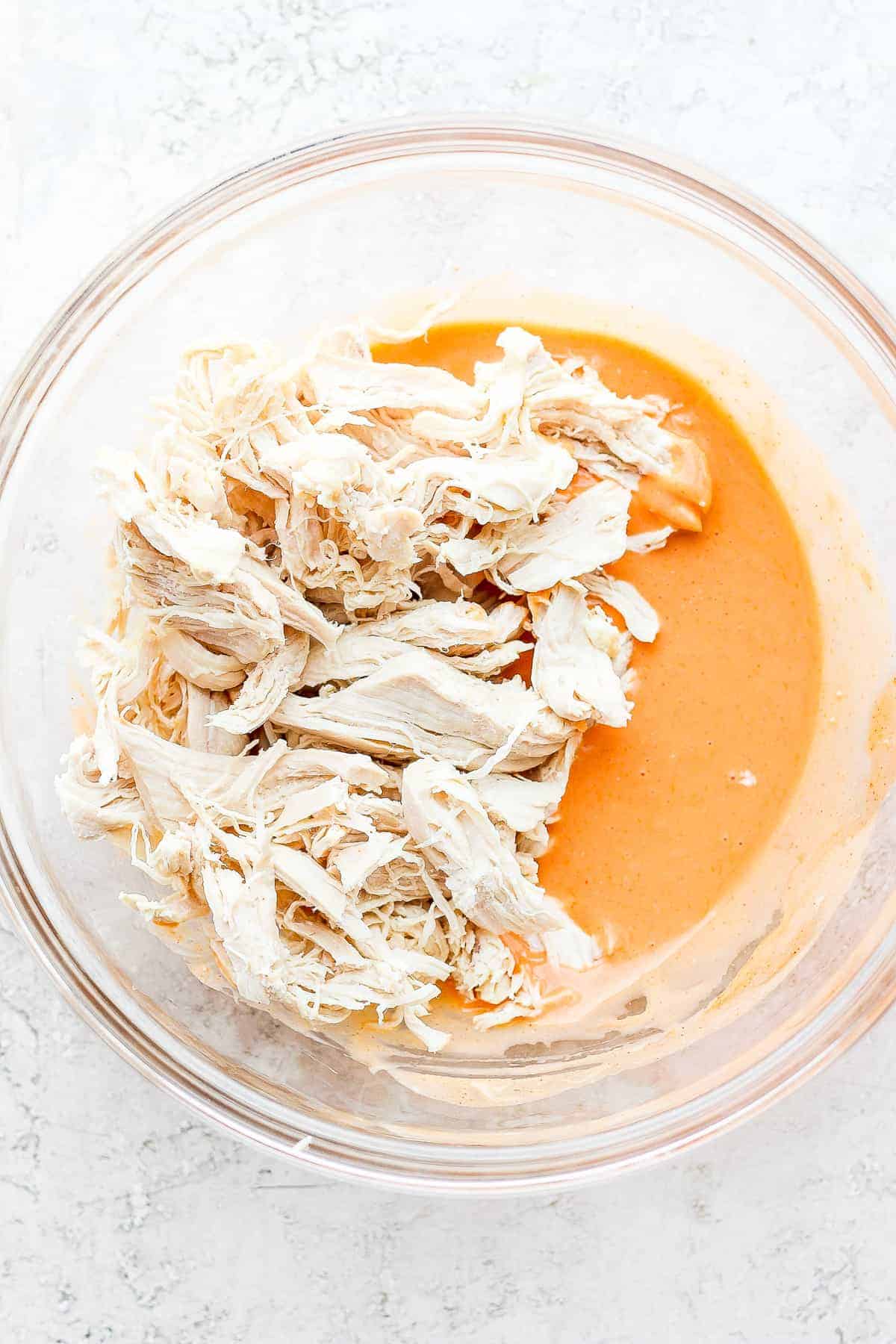 shredded chicken and buffalo sauce in bowl