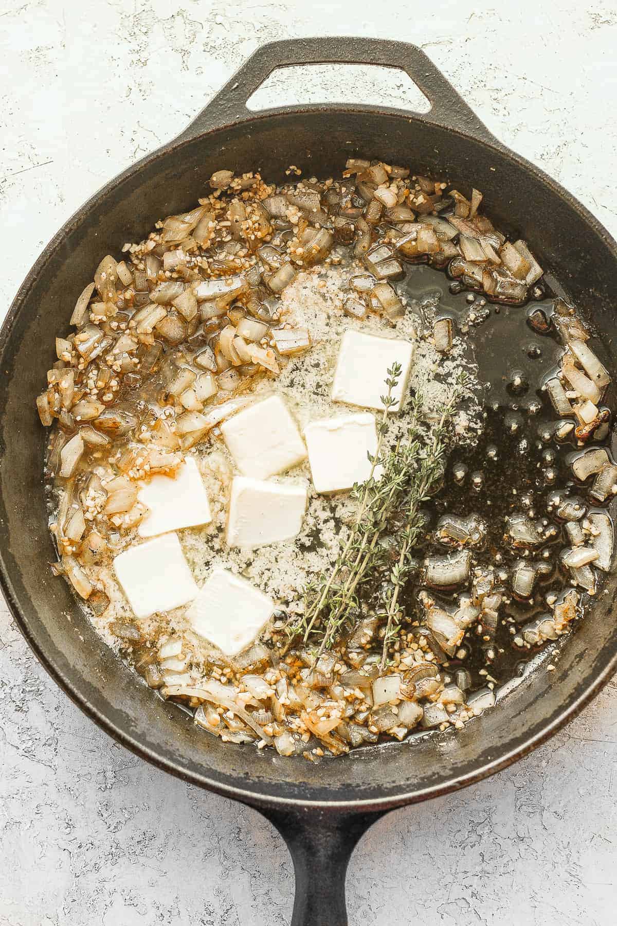 butter, onion and garlic sauteeing in a cast iron skillet