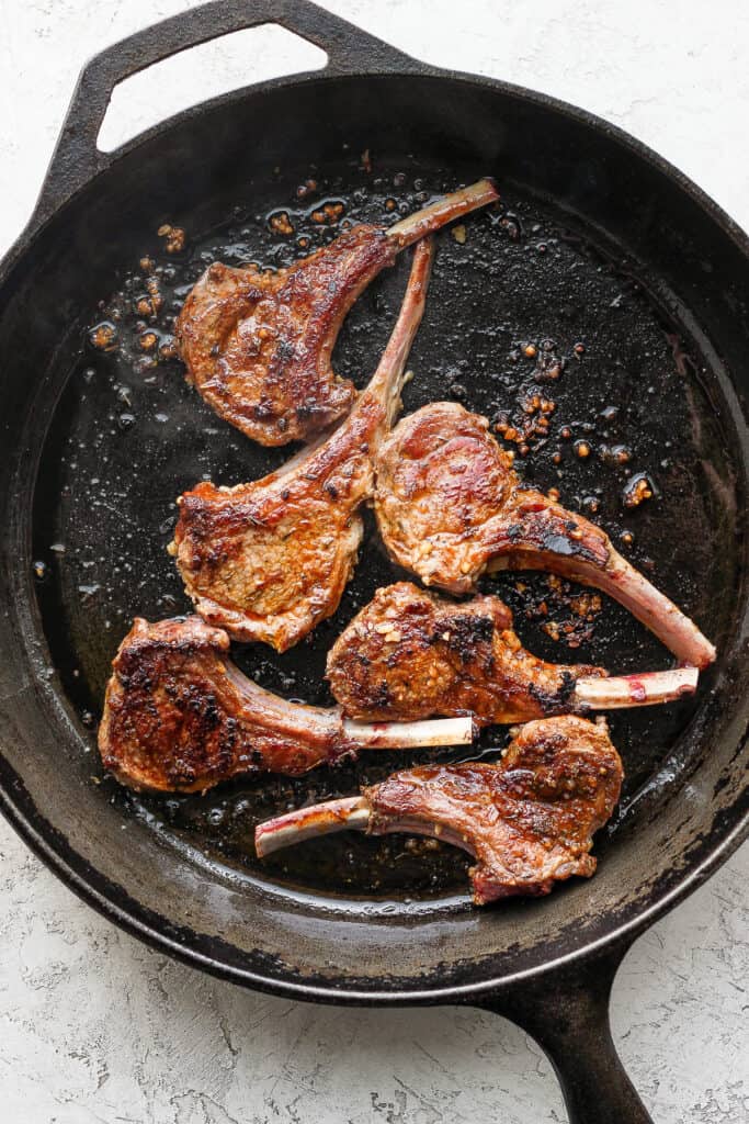 pan seared lamb chops in a cast iron skillet
