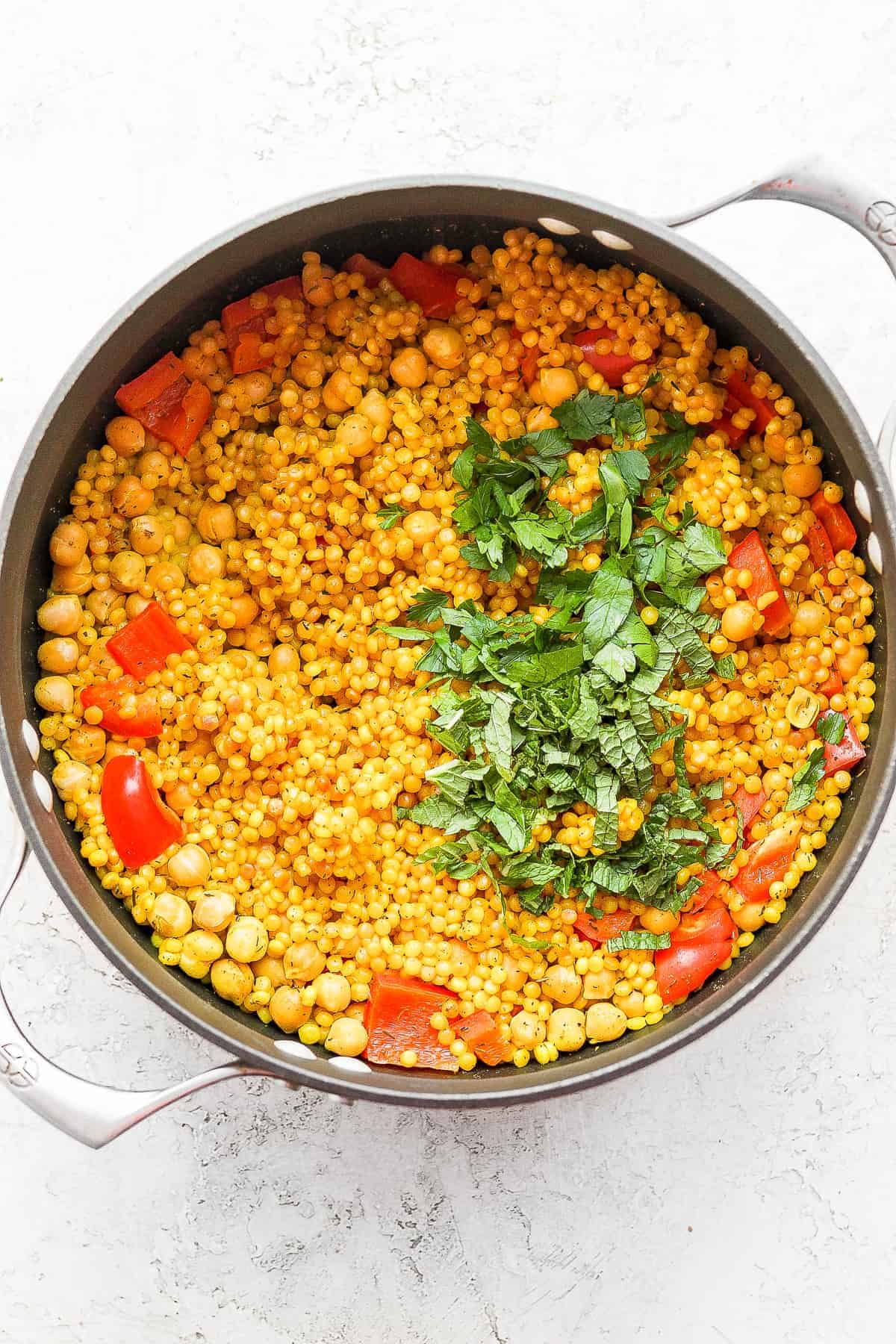 Fresh herbs on top of the cooked Israeli couscous. 