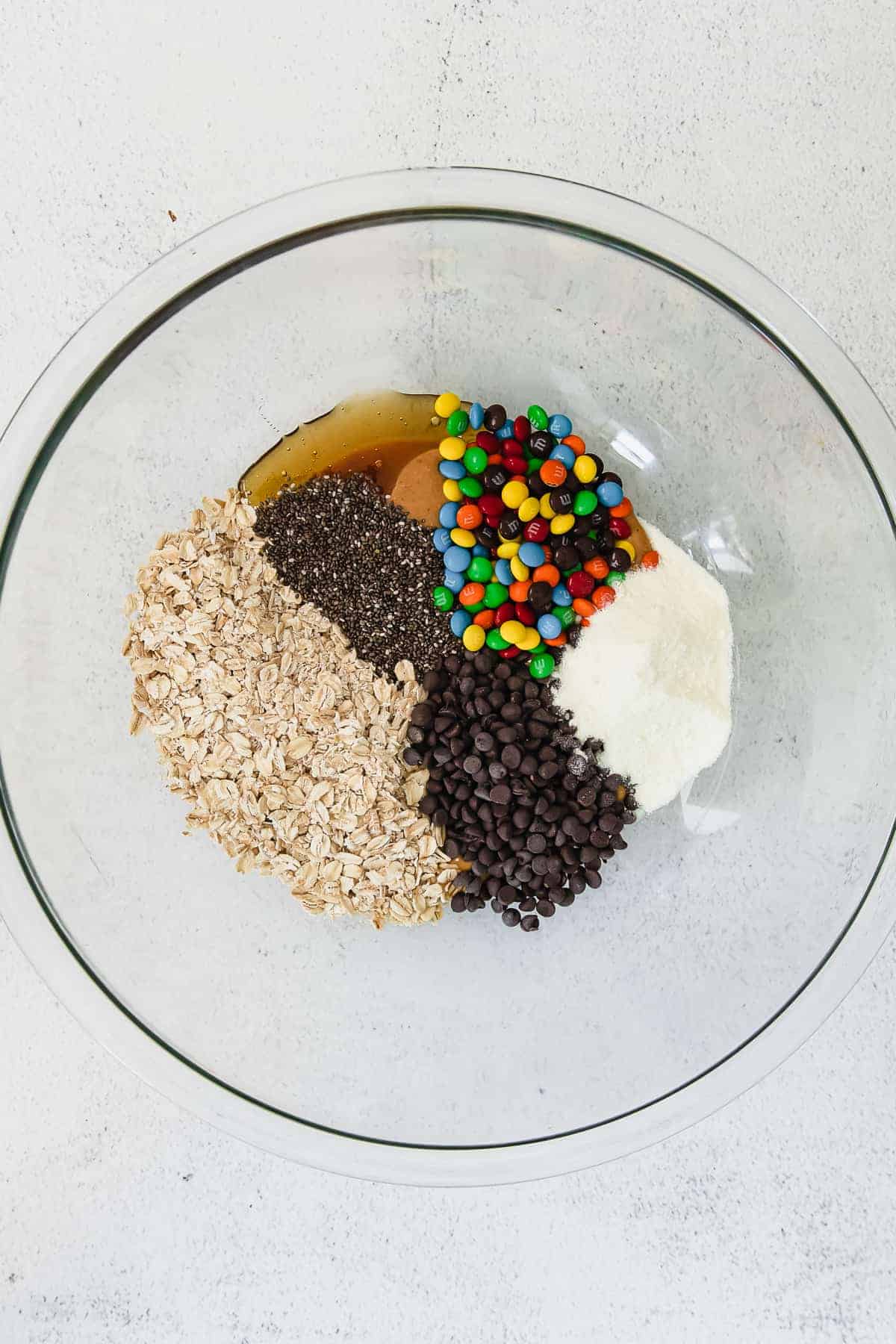 Oats, chocolate chips, marshmallows and chocolate chips in a bowl.