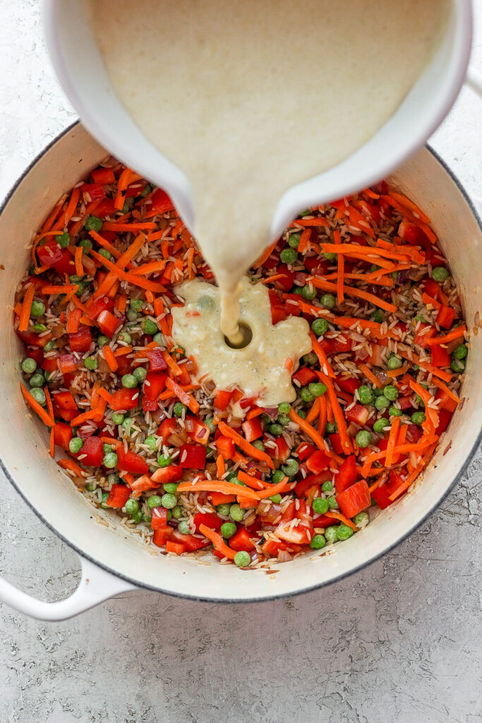 pouring curruy sauce over veggies