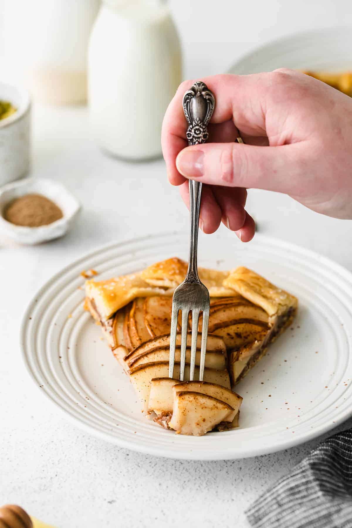 Taking a bit out of a piece of pear galette. 