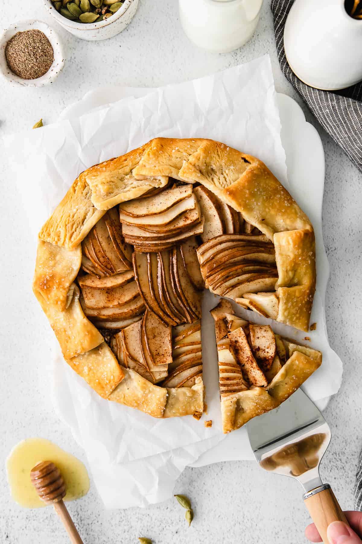 Removing a slice of a pear galatte with a spatula. 