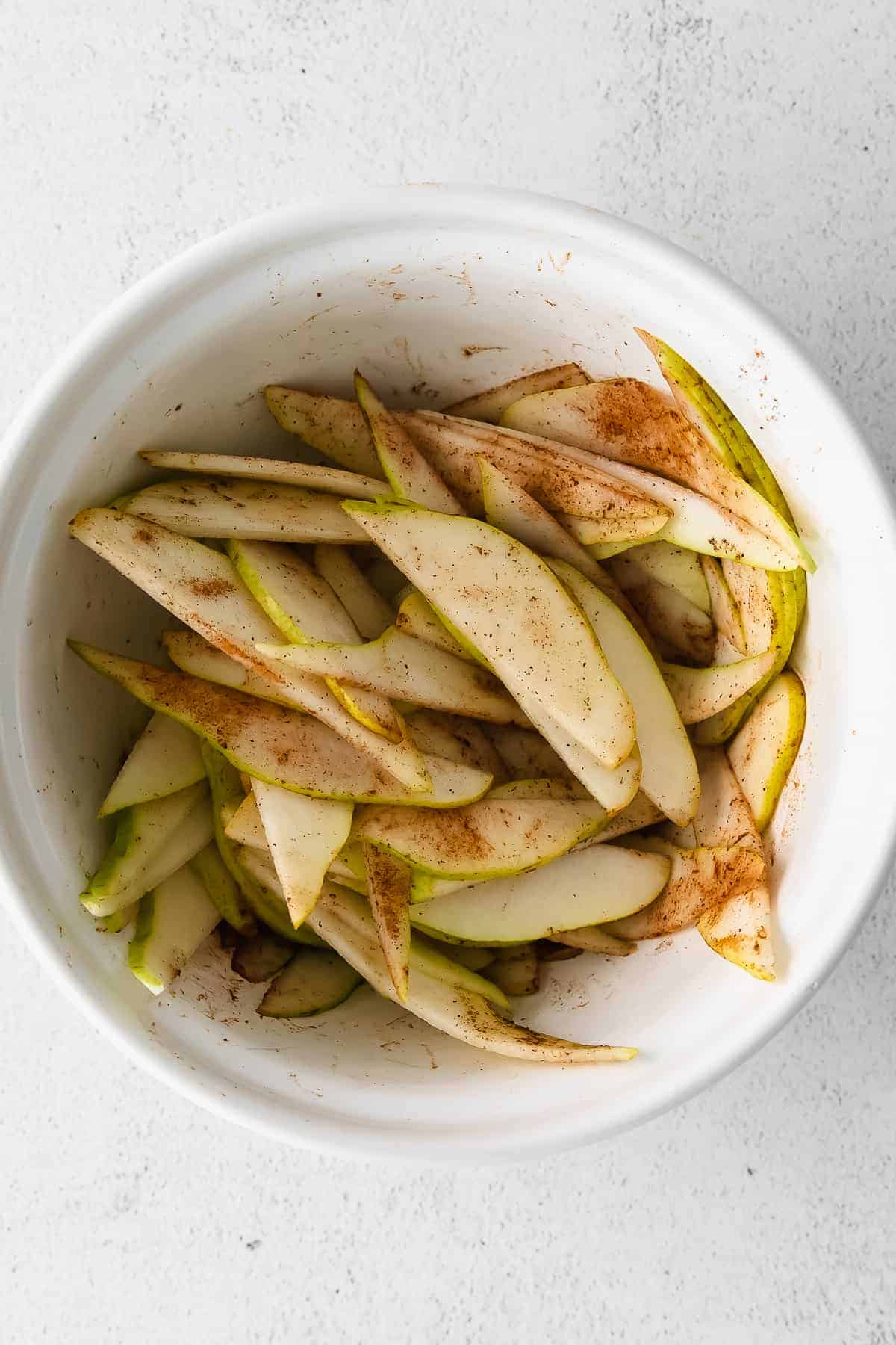 Pears and spices in a large bowl. 