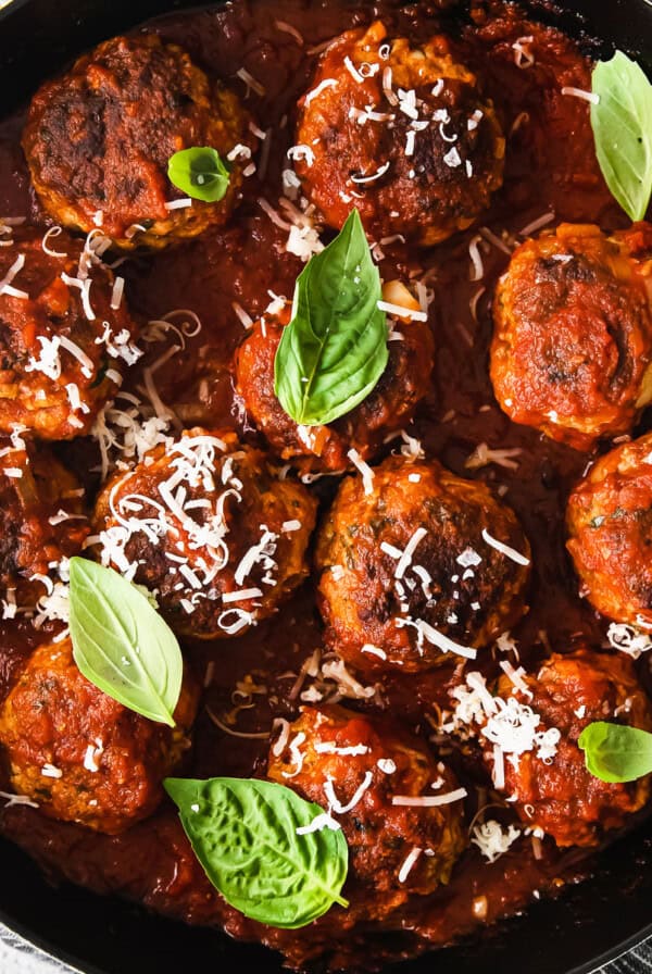 Meatballs in tomato sauce in a skillet.