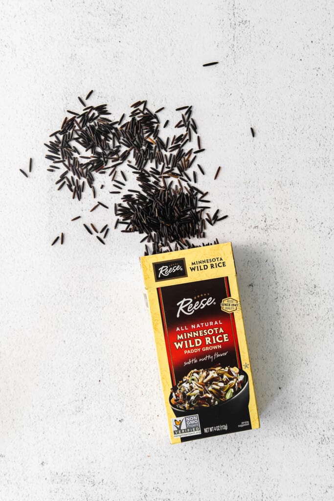 dry wild rice spilling out of a package of wild rice