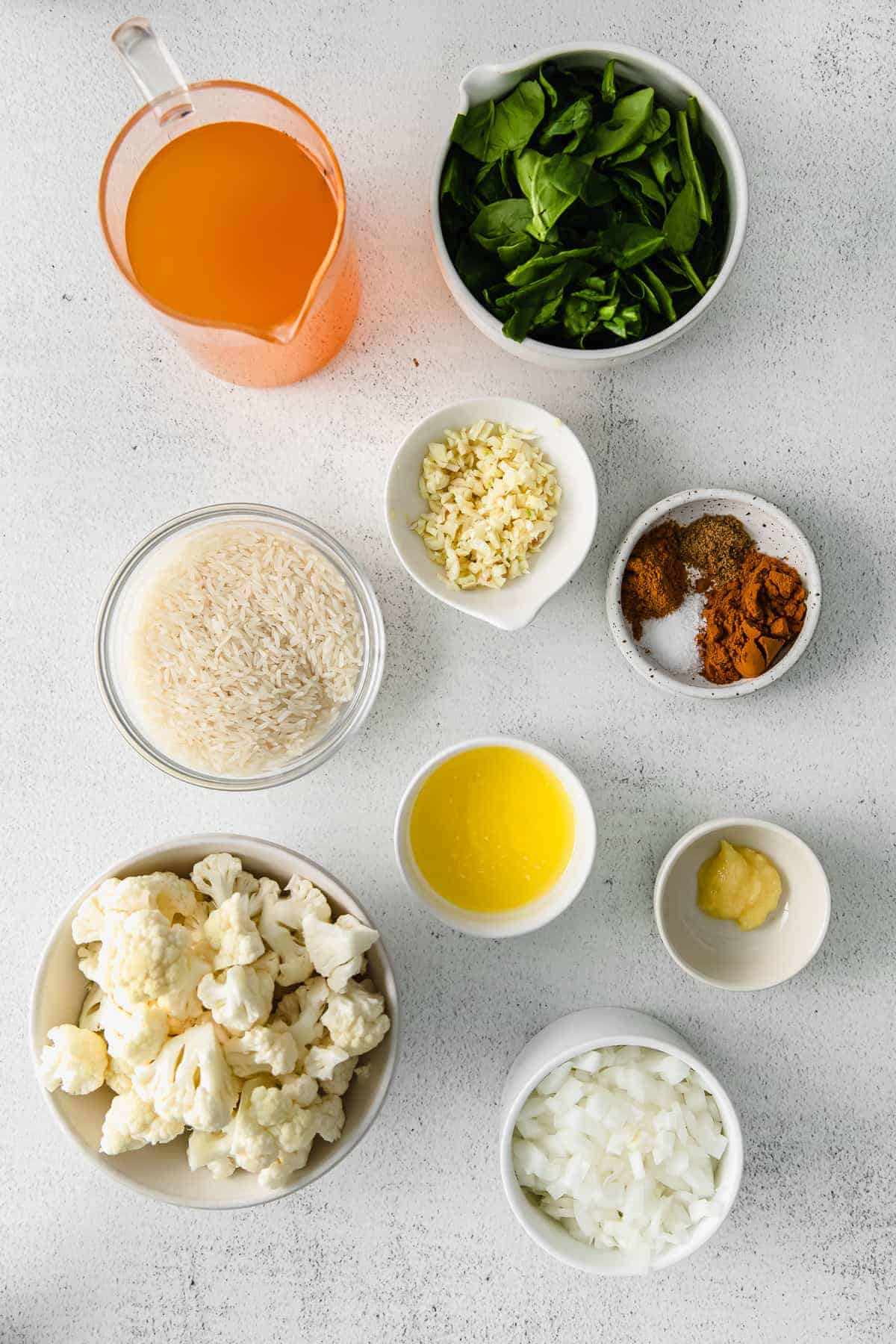 All the ingredients for one pot yellow rice in small bowls. 