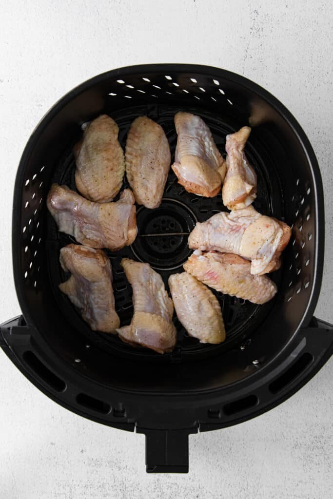 Raw chicken wings in the air fryer. 