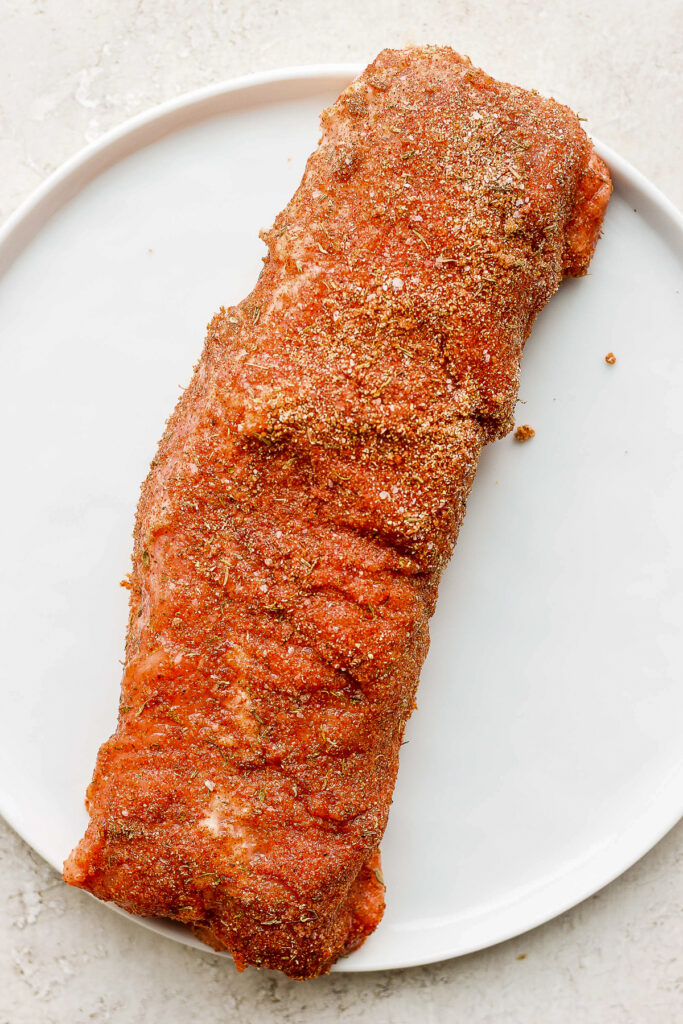 pork tenderloin on a plate with a dry rub