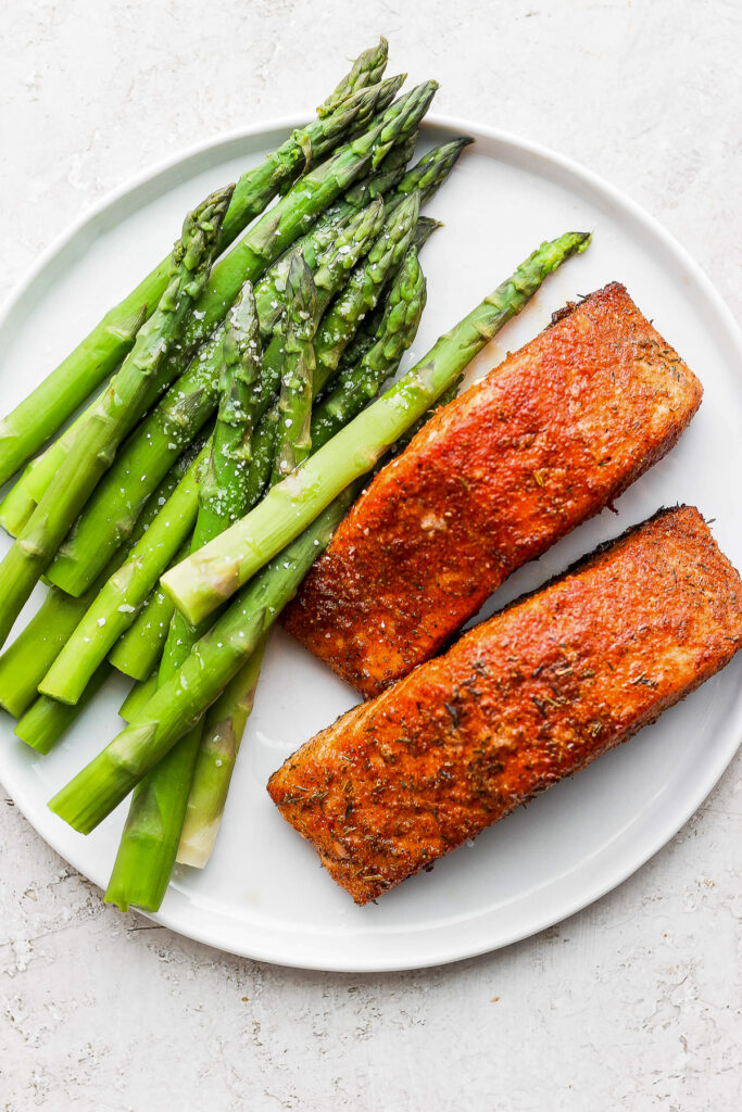 air fryer salmon and asparagus on plate.