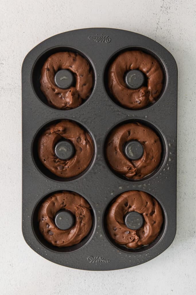 batter piped into donut mold