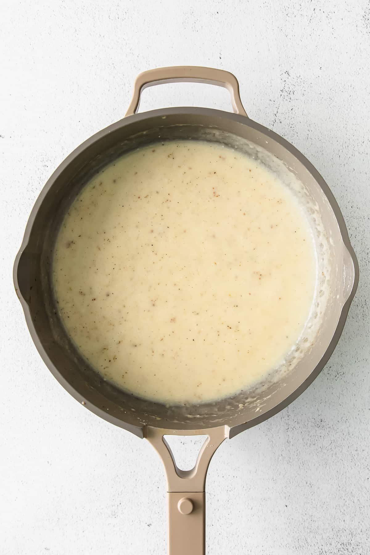 Alfredo sauce in a pan. 