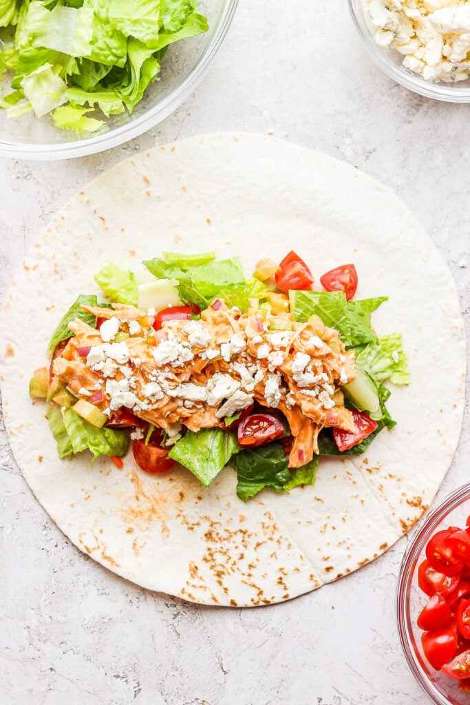 https://fitfoodiefinds.com/wp-content/uploads/2022/01/Buffalo-Chicken-Wrap-04-1-683x1024.jpg