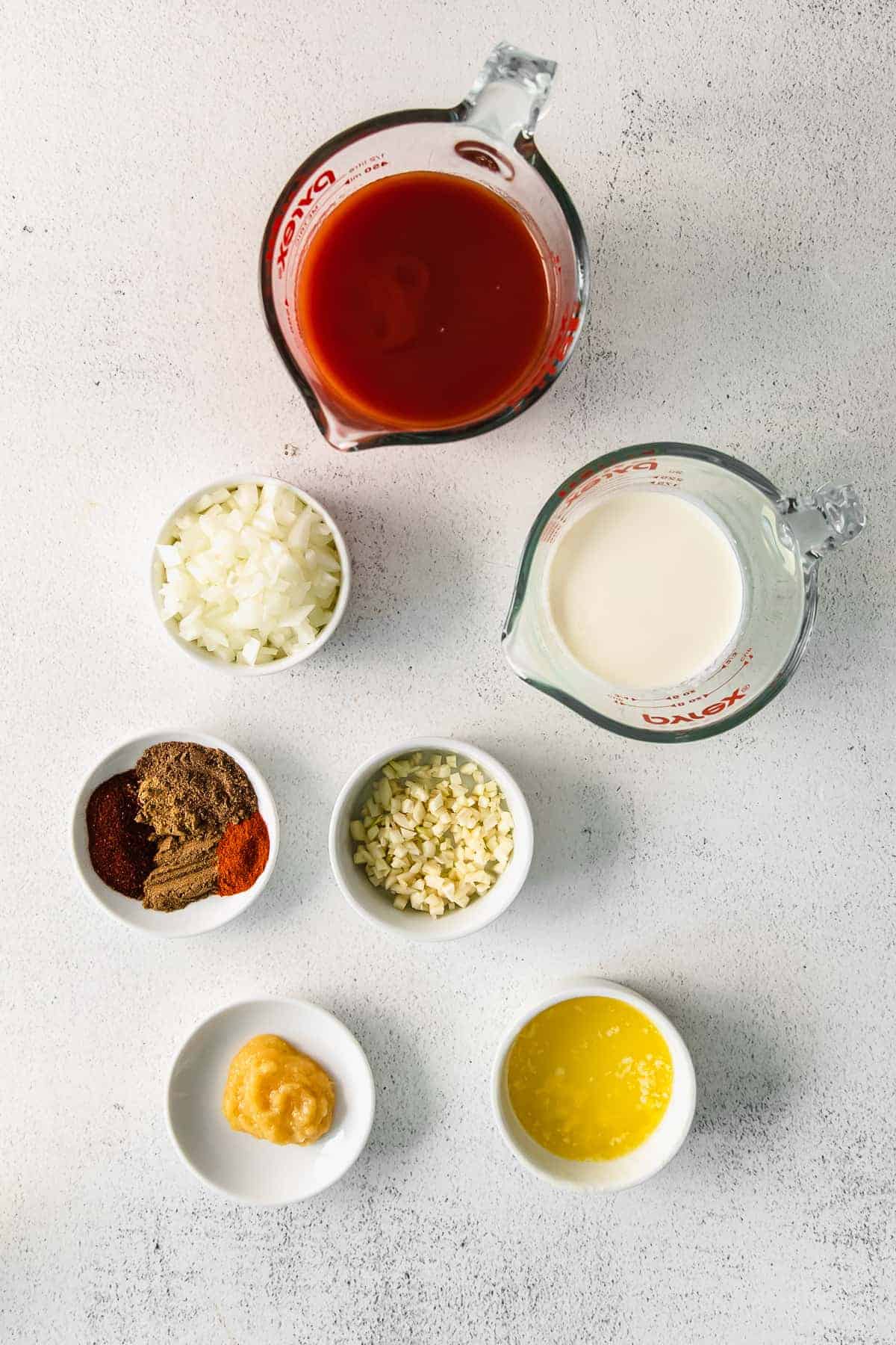 Tomato sauce, garam masala, and other ingredients for butter chicken. 