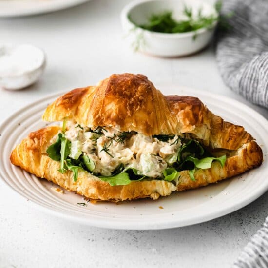 A croissant sandwich with chicken salad on a plate.