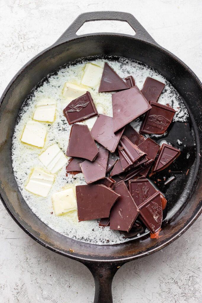 bittersweet chocolate and butter melting in a cast iron skillet