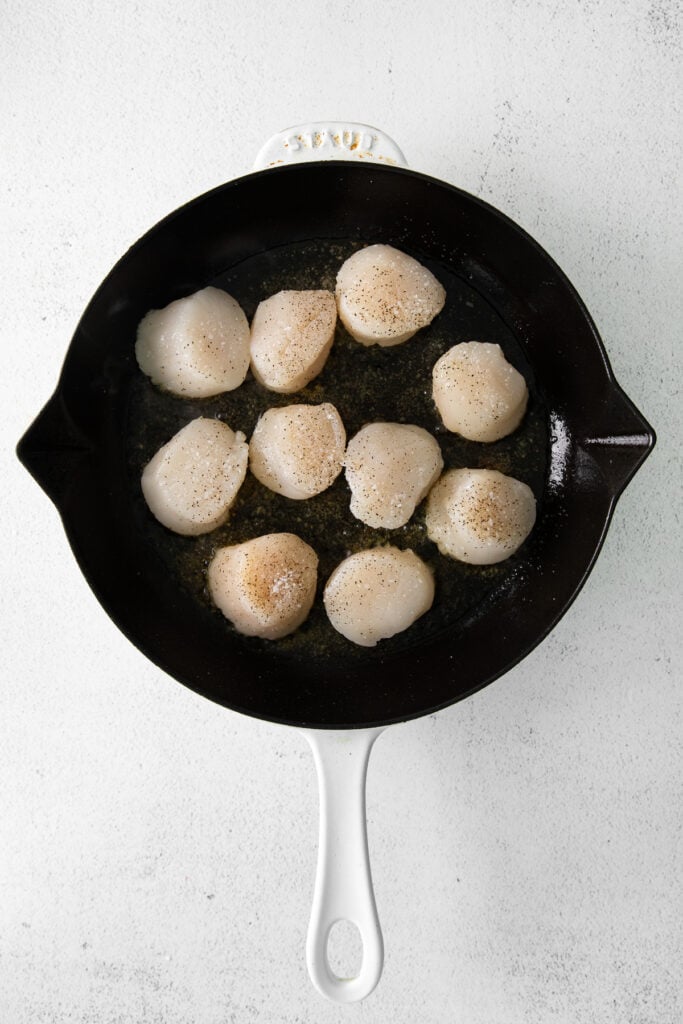 Scallops in a cast iron pan. 