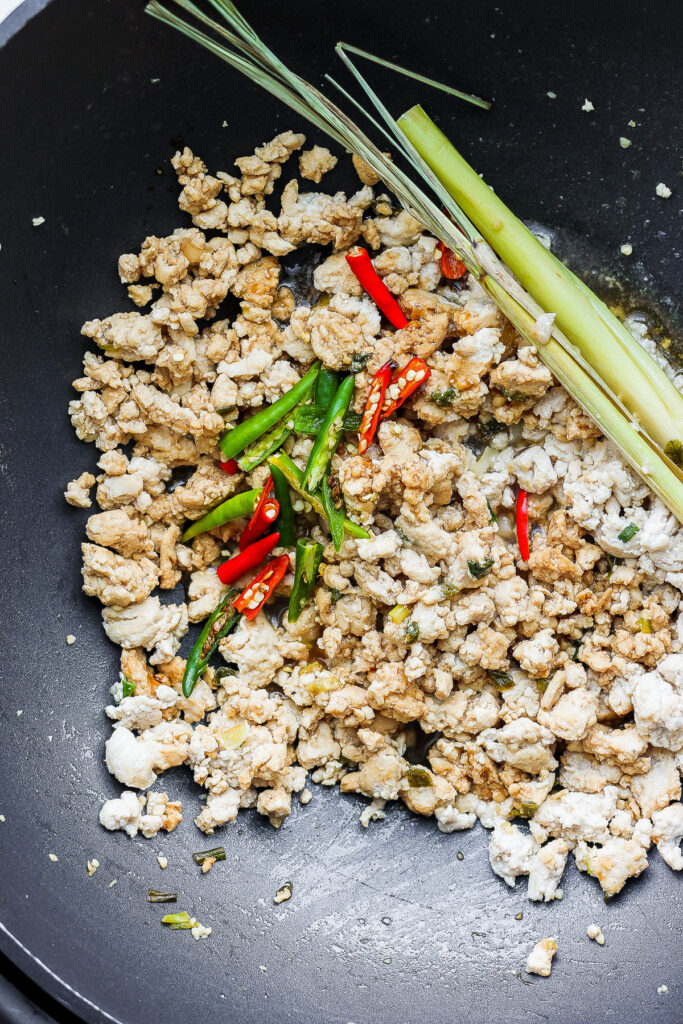 cooked chicken with chili peppers in wok