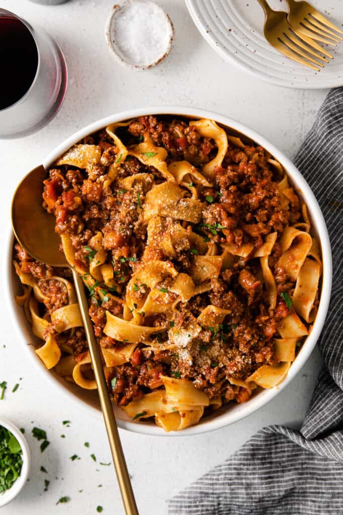 slow cooker bolognese with pasta in a dish with a spoon