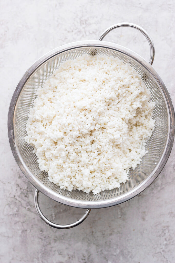 sticky rice in a strainer