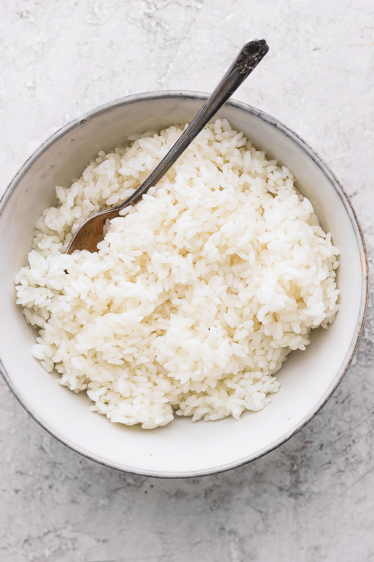sticky rice in a bowl with a spoon
