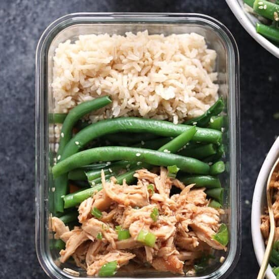 A bowl of rice and green beans with crock pot honey garlic chicken in a plastic container.