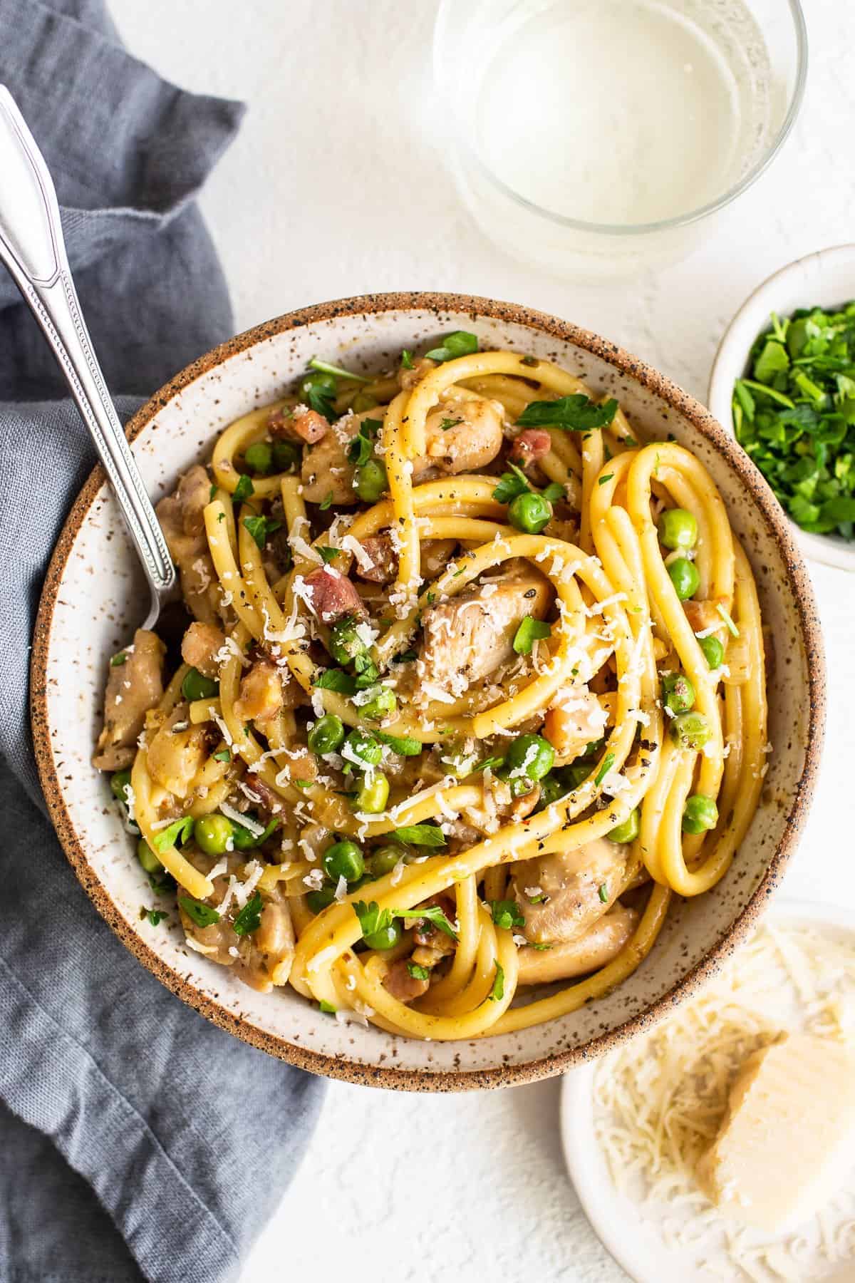 Chicken carbonara in a bowl with a spoon.