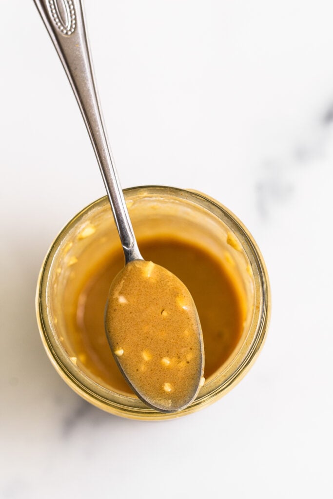 Honey mustard dressing in a mason jar. 