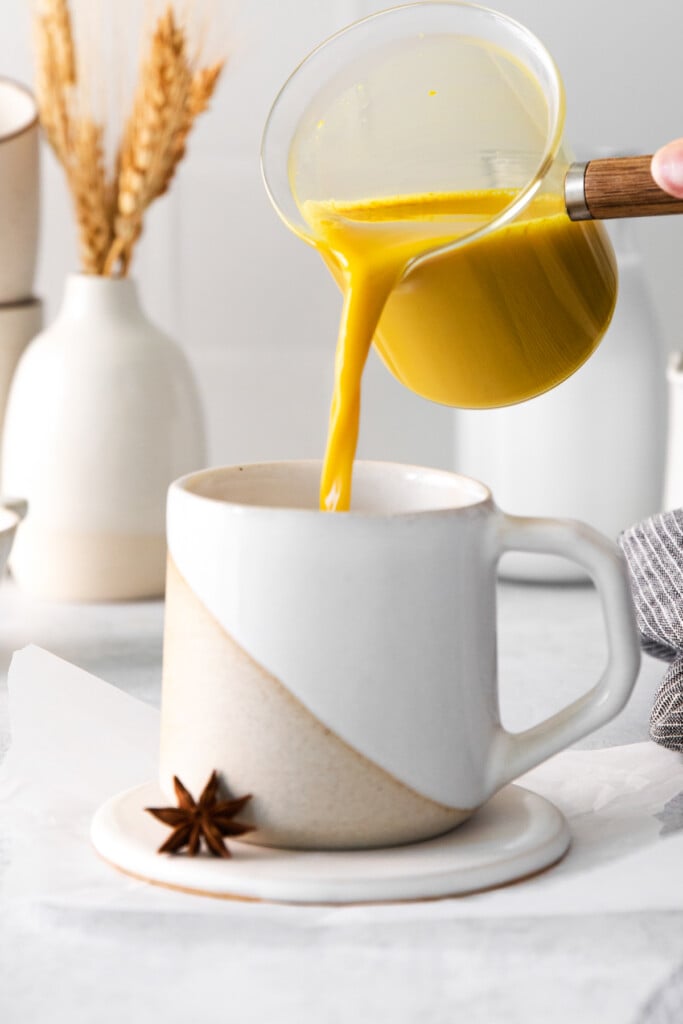 pouring latte into glass