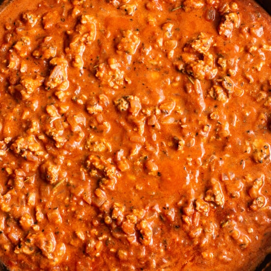 A skillet filled with meat and sauce.
